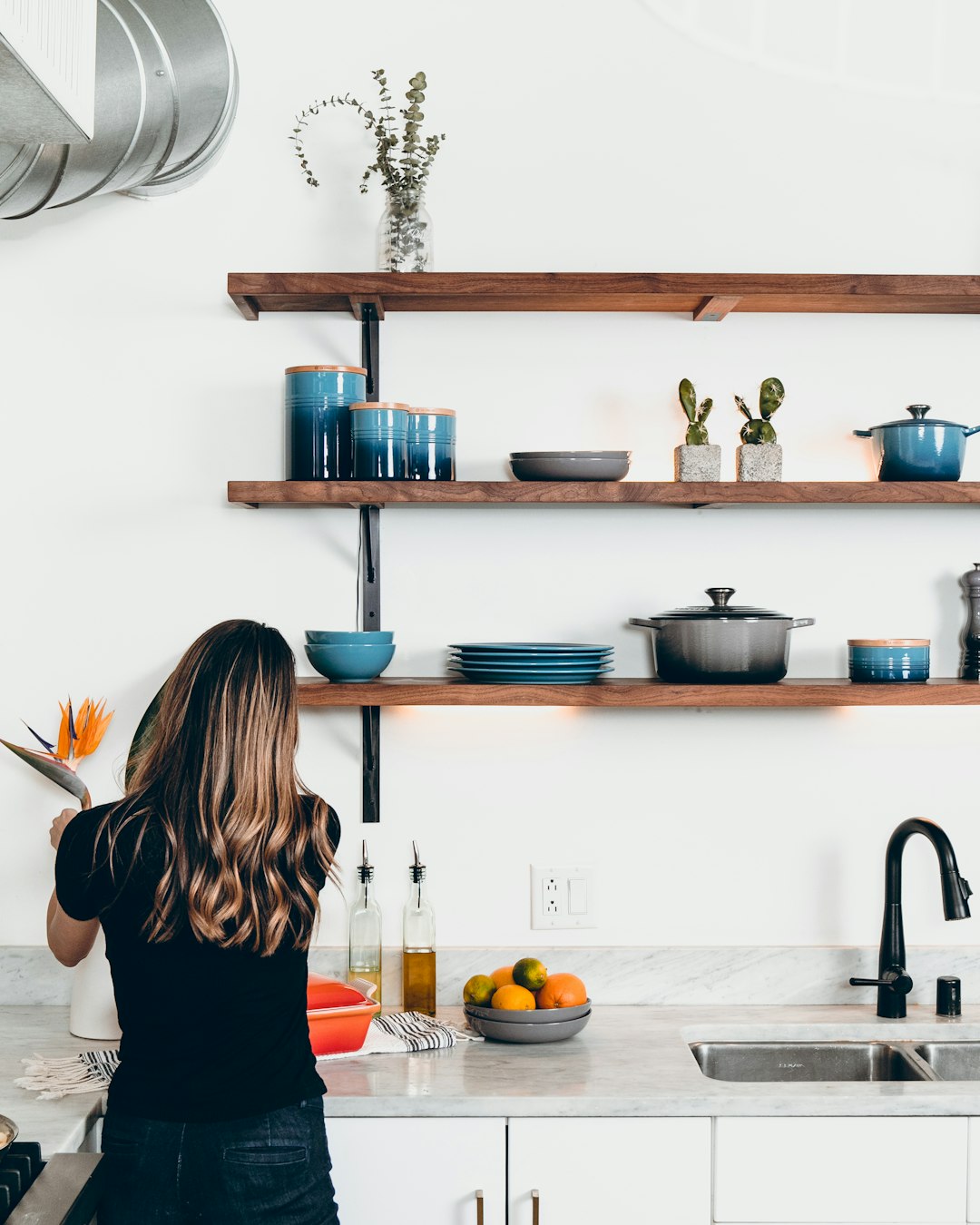 services-01 woman-standing-in-front-of-kitchen-sink-1wfxk3wjxzu